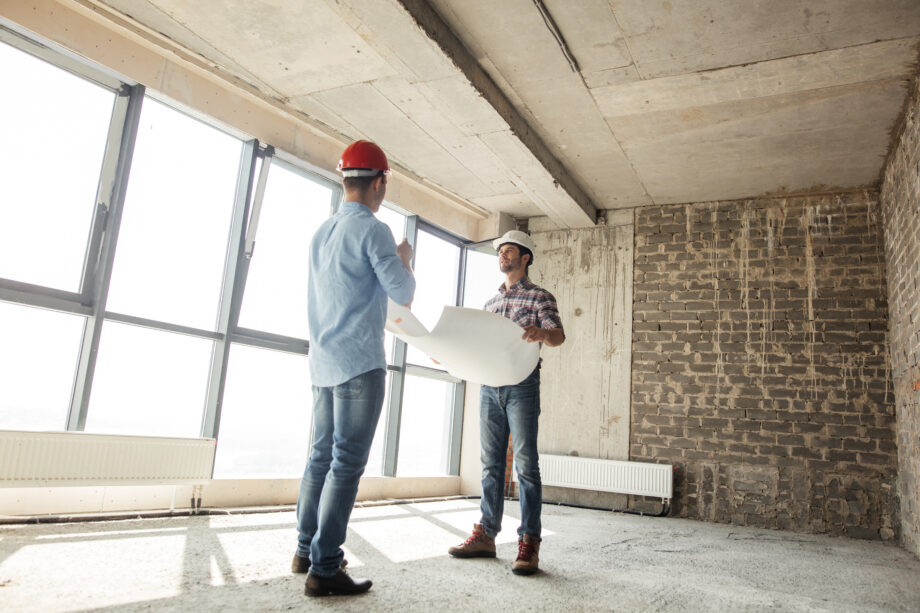 Low,Angle,View.,A,Team,Of,Builders,Are,Discussing,A